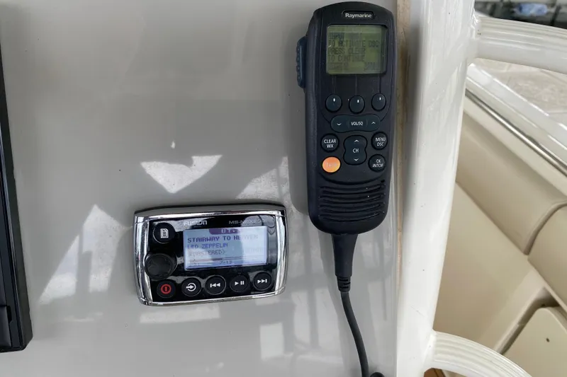 Slide: The Image of Control panel of a 2016 Boston Whaler 330 Outrage with radio and navigation equipment. - 21