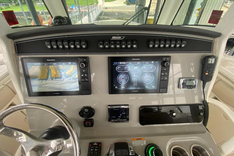 Slide: The Image of Control panel of a 2016 Boston Whaler 330 Outrage with navigation screens and controls. - 22