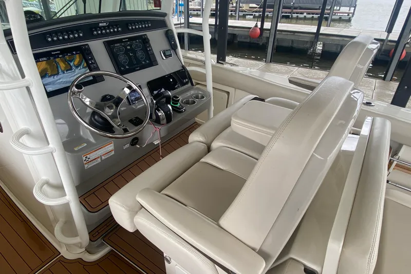 Slide: The Image of 2016 Boston Whaler 330 Outrage helm with modern controls and comfortable seating. - 29