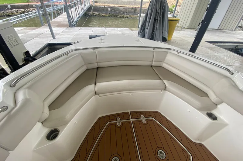 Slide: The Image of 2016 Boston Whaler 330 Outrage boat interior with cushioned seating and teak flooring. - 30
