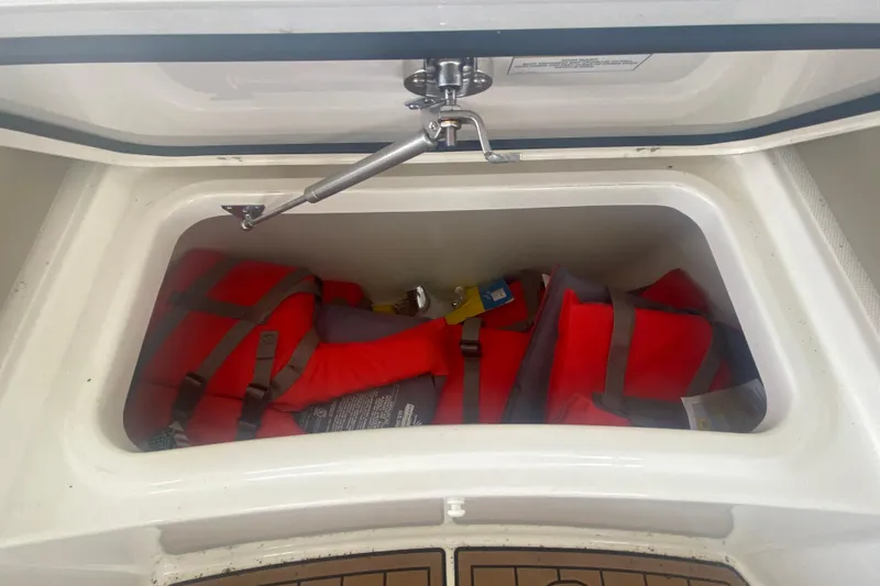 Slide: The Image of Storage compartment with life jackets on a 2016 Boston Whaler 330 Outrage boat. - 34
