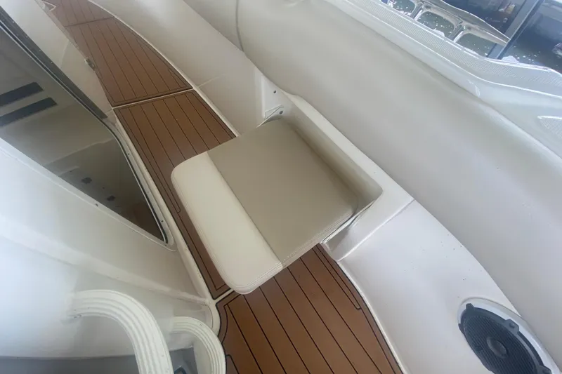 Slide: The Image of 2016 Boston Whaler 330 Outrage interior with cushioned seat and teak flooring. - 38