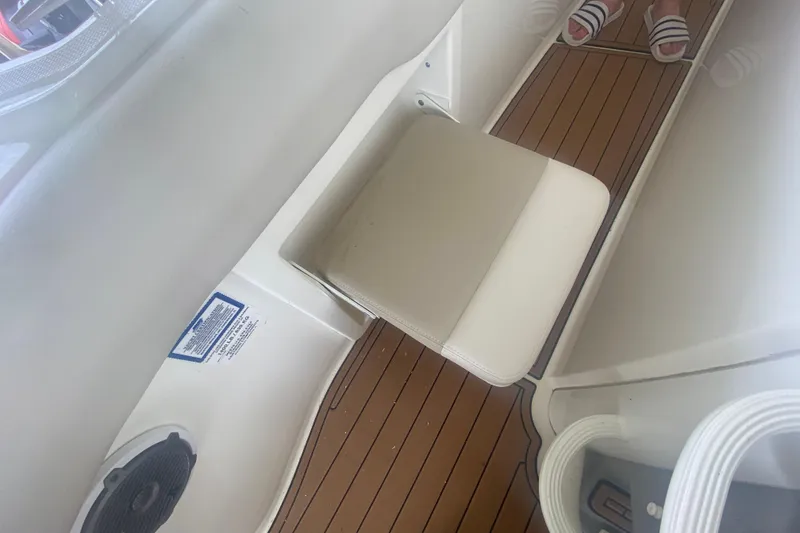 Slide: The Image of Interior of 2016 Boston Whaler 330 Outrage with cushioned seat and teak flooring. - 39
