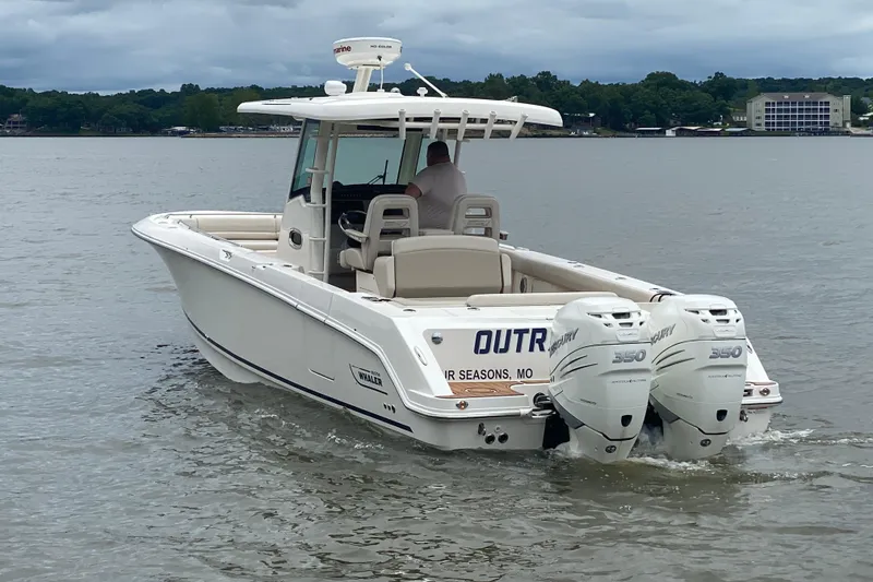 Slide: The Image of 2016 Boston Whaler 330 Outrage boat with twin Mercury 350 engines on a lake. - 4