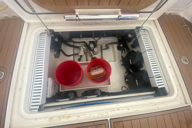 Slide: The Image of Open hatch of a 2016 Boston Whaler 330 Outrage showing storage and equipment. - 40