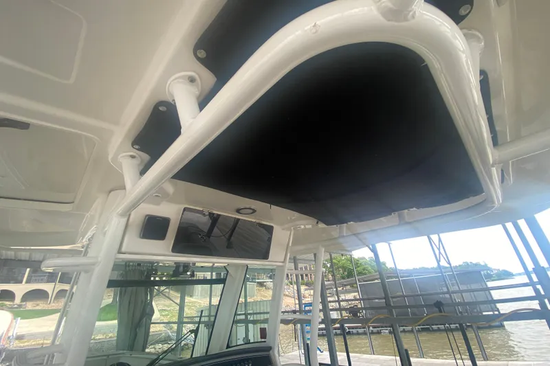 Slide: The Image of Boston Whaler 330 Outrage 2016 boat interior with overhead view and water backdrop. - 44