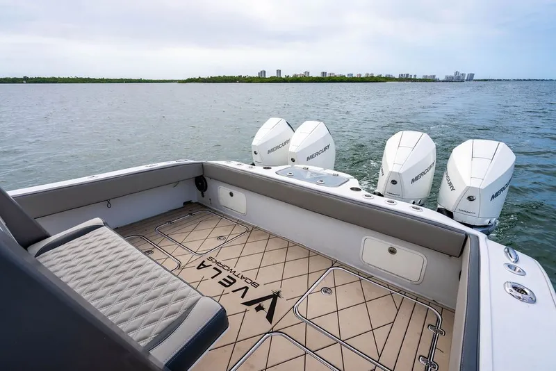 Slide: The Image of View of a boat's stern with four outboard engines on calm water. - 11