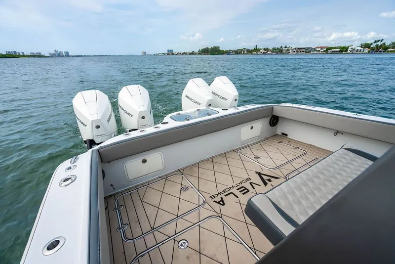 Slide: The Image of The image shows a modern boat with four outboard engines on calm water. - 12