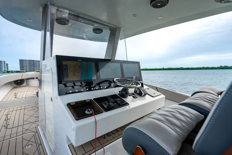 Slide: The Image of The image shows a modern boat cockpit with multiple screens and gray seating. - 18