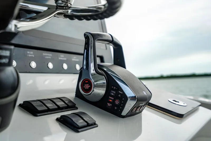 Slide: The Image of Close-up of a modern boat's control console with lever and buttons. - 23