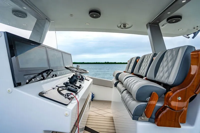Slide: The Image of Interior view of a modern boat with gray seating and a large helm console. - 24