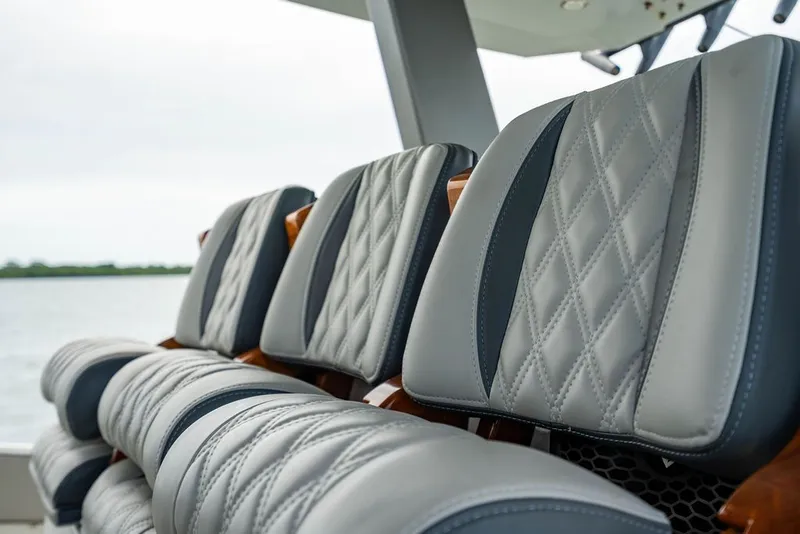 Slide: The Image of Close-up of gray quilted boat seats with black accents. - 26
