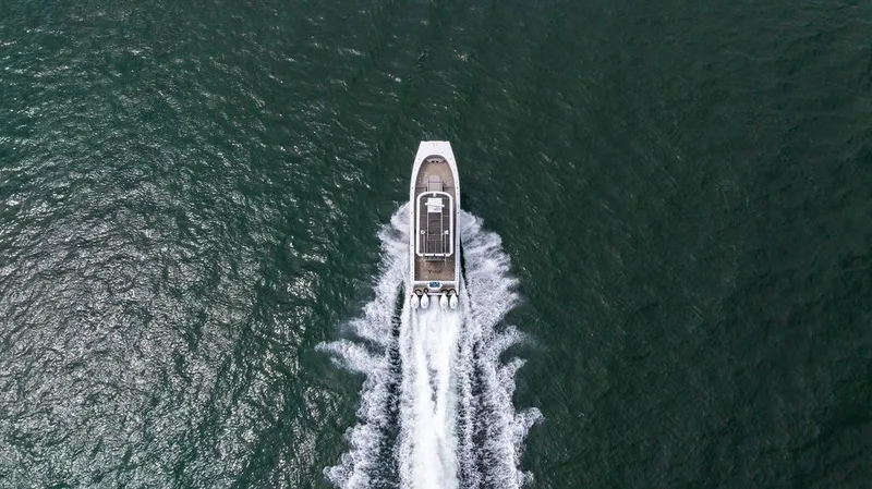 Slide: The Image of Aerial view of a boat on the water with three outboard engines. - 3