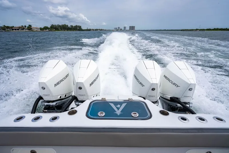 Slide: The Image of Four powerful outboard engines propel the boat across the water. - 38