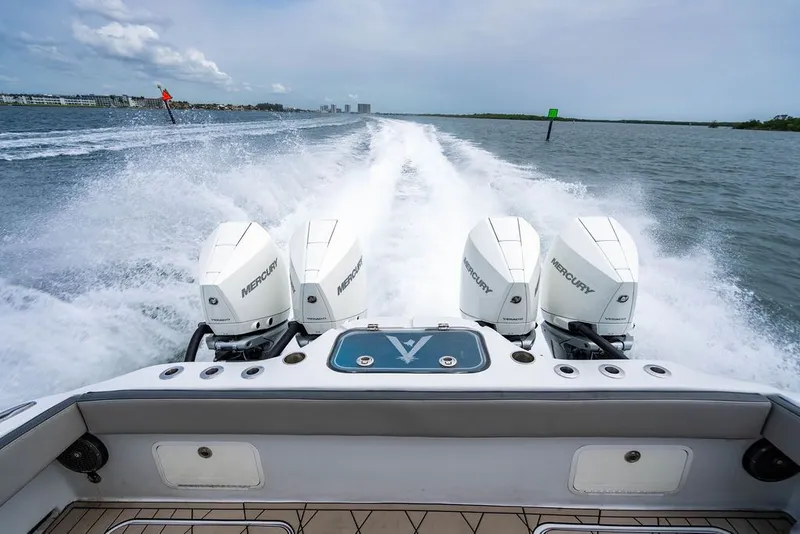Slide: The Image of The boat speeds across the water with three Mercury engines. - 39