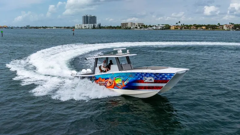 Slide: The Image of A 2021 Custom 368 Center Console boat speeding on the water. - 4