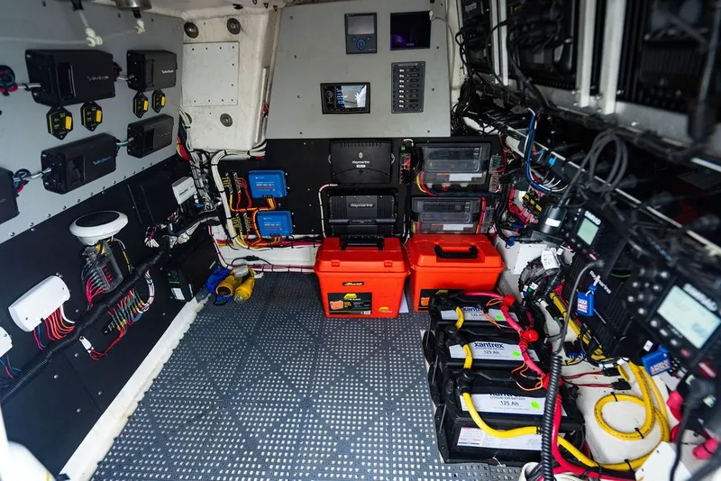 Slide: The Image of Electronics and battery room of a boat with various devices and wiring. - 40