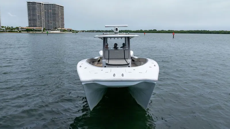 Slide: The Image of Custom 368 Center Console 2021 on the water with high-rise buildings in the background. - 5