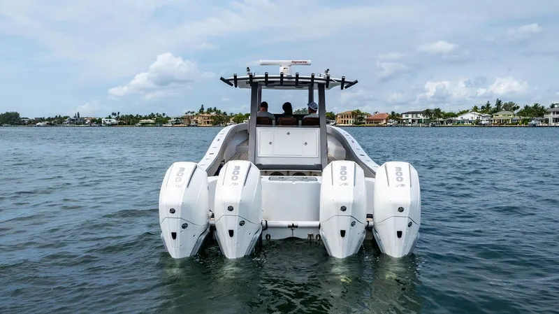 Slide: The Image of Custom 368 Center Console 2021 on the water with four outboard engines. - 8