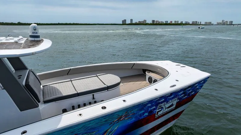 Slide: The Image of Custom 368 Center Console 2021 on the water with city skyline in the background. - 9