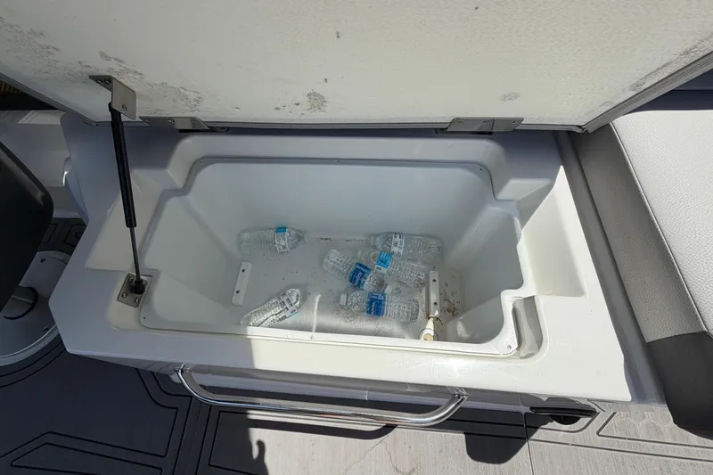 Slide: The Image of An open cooler compartment with several water bottles inside. - 11