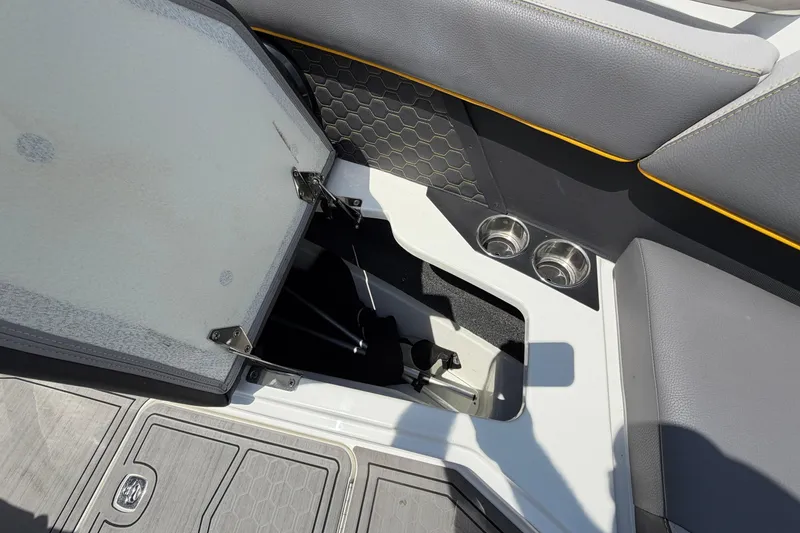 Slide: The Image of Interior view of a Cobalt R8 Surf boat with storage compartment and cup holders. - 12