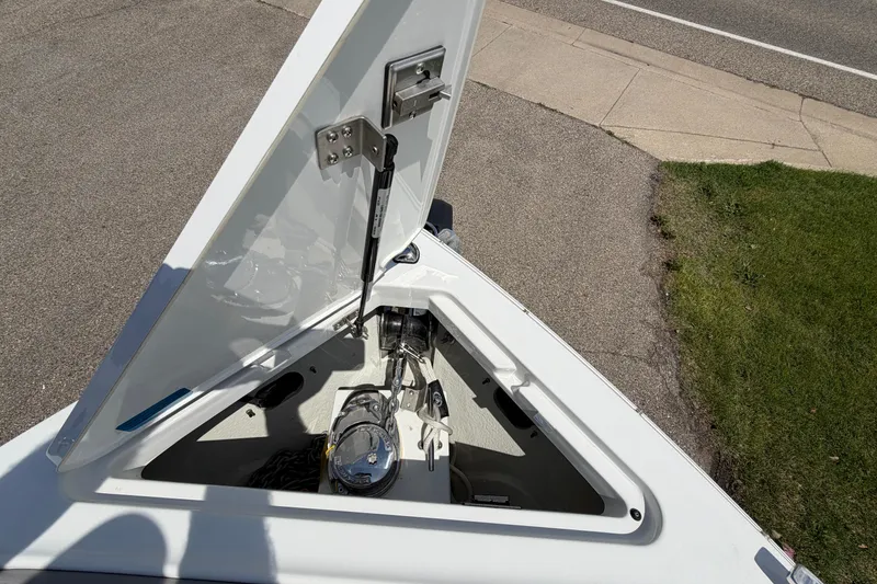 Slide: The Image of Open anchor compartment of 2021 Cobalt R8 Surf boat, showing mechanical details. - 15