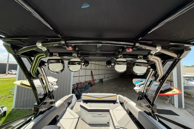 Slide: The Image of 2021 Cobalt R8 Surf boat interior with speakers and surfboards in storage. - 17