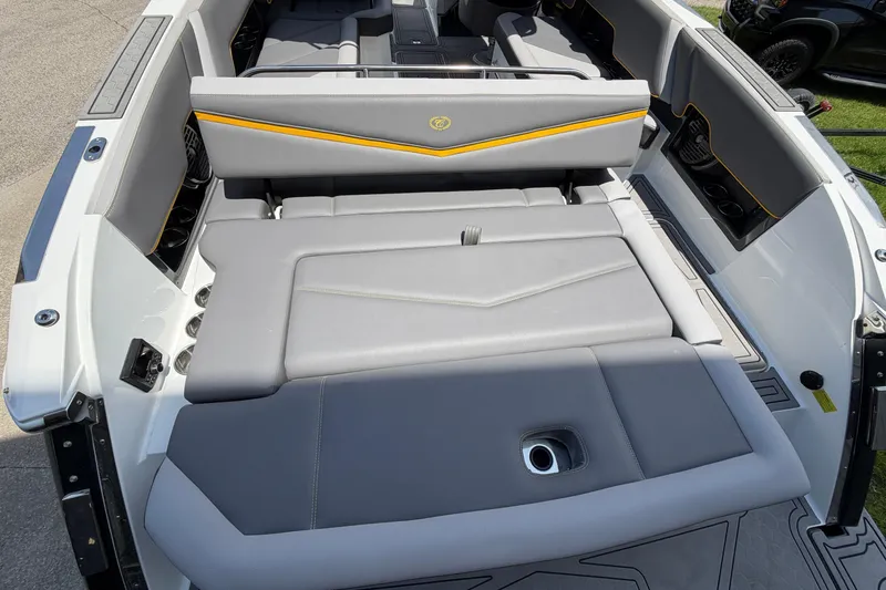 Slide: The Image of The image shows the stern of a 2021 Cobalt R8 Surf boat with gray upholstery. - 19