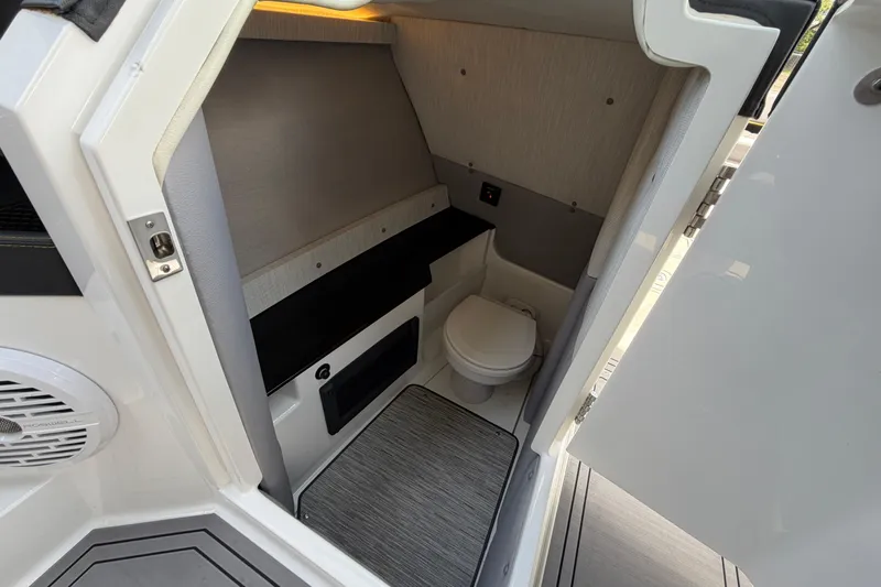 Slide: The Image of Interior of 2021 Cobalt R8 Surf boat featuring a compact, modern bathroom. - 26