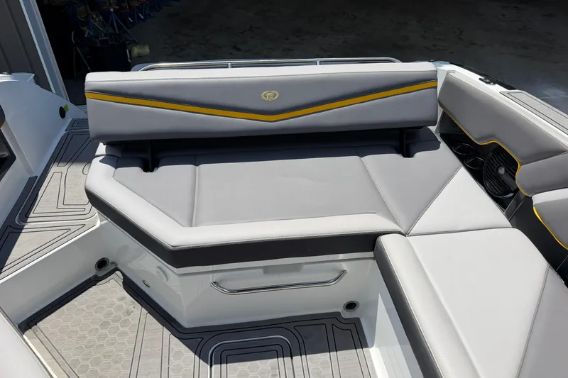 Slide: The Image of 2021 Cobalt R8 Surf boat interior with gray seating and yellow accents. - 31