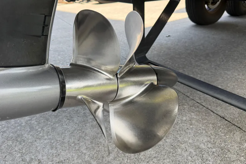 Slide: The Image of Close-up of a 2021 Cobalt R8 Surf boat propeller on a concrete surface. - 36