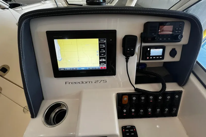 Slide: The Image of Control panel of 2014 Grady-White Freedom 275 boat with navigation and communication equipment. - 11