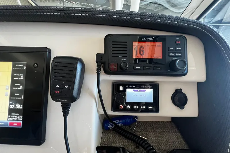 Slide: The Image of Control panel of a 2014 Grady-White Freedom 275 boat with Garmin and Fusion devices. - 14