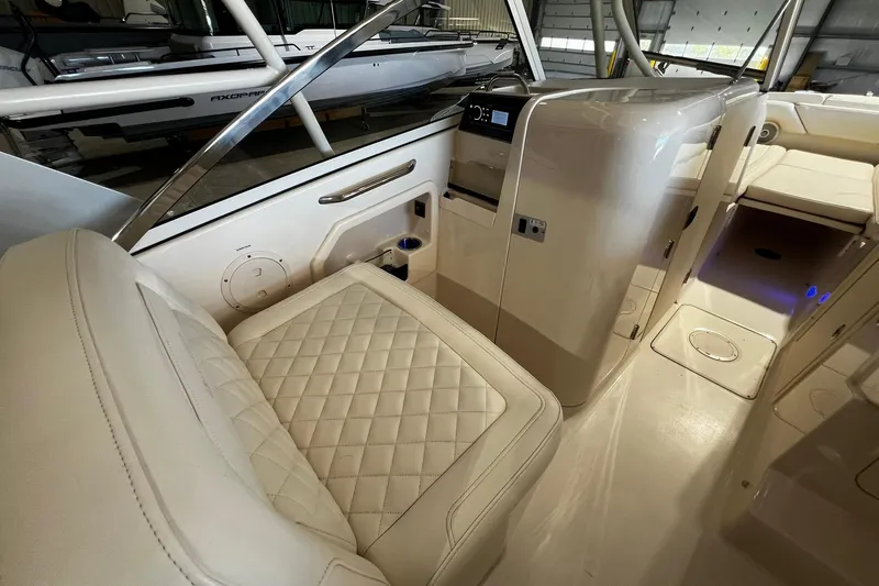 Slide: The Image of 2014 Grady-White Freedom 275 boat interior with luxurious seating and modern controls. - 18