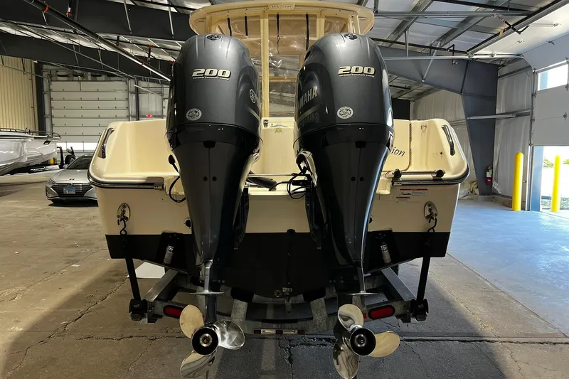 Slide: The Image of 2014 Grady-White Freedom 275 boat with twin Yamaha 200 engines in a garage. - 2