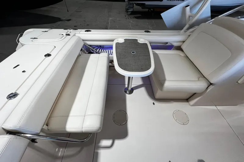 Slide: The Image of 2014 Grady-White Freedom 275 boat interior with seating and table setup. - 21
