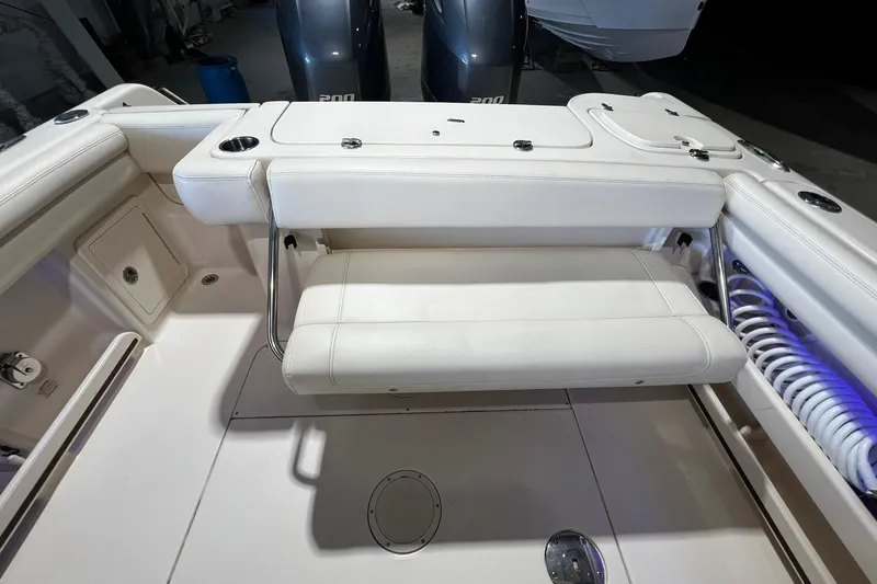 Slide: The Image of 2014 Grady-White Freedom 275 boat interior with foldable seating and twin engines. - 24