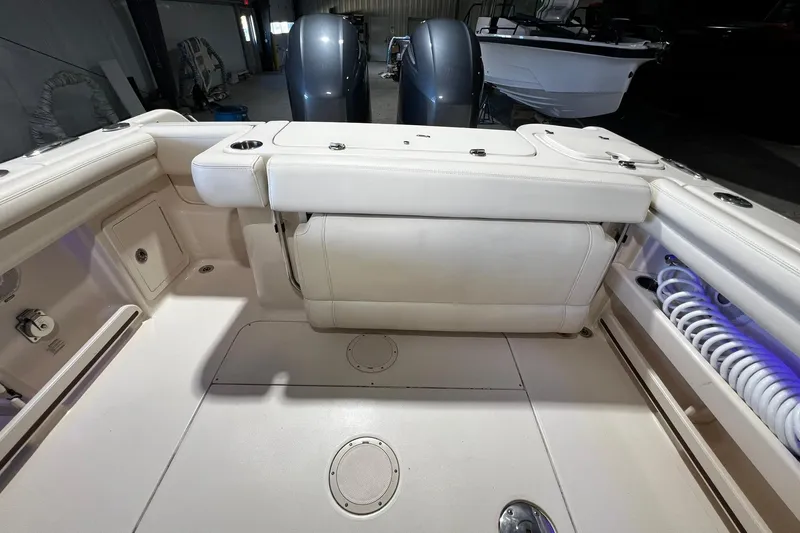 Slide: The Image of 2014 Grady-White Freedom 275 boat interior with seating and storage compartments. - 25