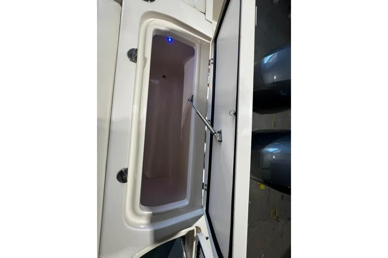 Slide: The Image of Open storage compartment on 2014 Grady-White Freedom 275 boat. - 27