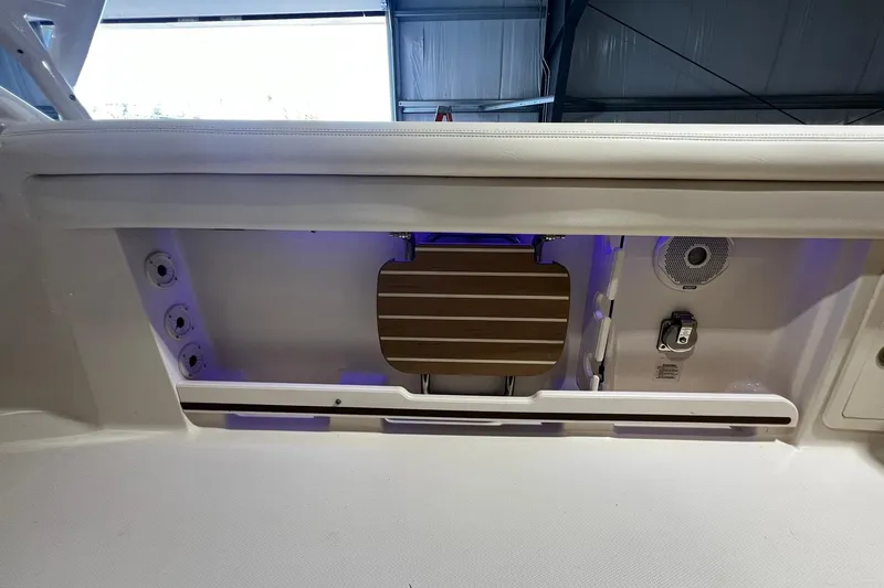 Slide: The Image of 2014 Grady-White Freedom 275 boat interior with seating and storage features. - 28