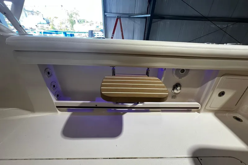 Slide: The Image of 2014 Grady-White Freedom 275 boat interior with wooden step and storage compartments. - 29