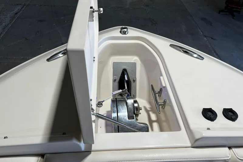 Slide: The Image of 2014 Grady-White Freedom 275 boat anchor compartment with open hatch and winch system. - 3