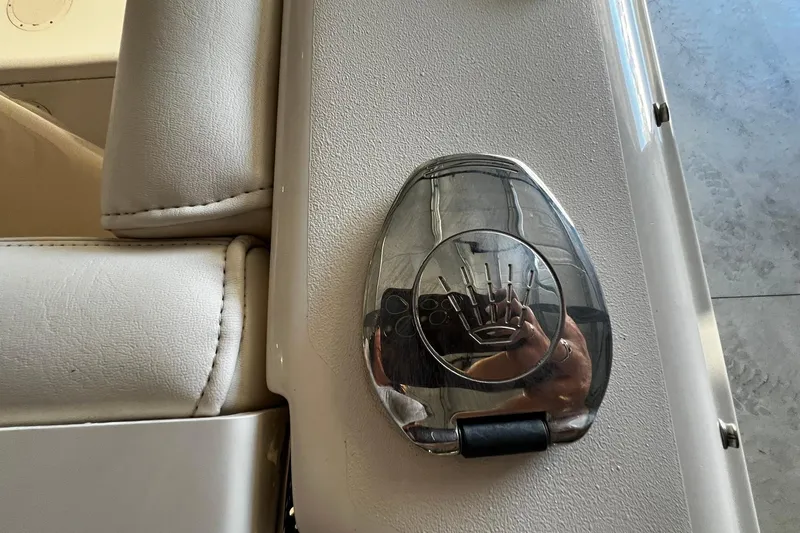 Slide: The Image of Chrome latch on 2014 Grady-White Freedom 275 boat seat, reflecting surroundings. - 32