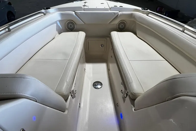 Slide: The Image of 2014 Grady-White Freedom 275 boat interior with cushioned seating and speakers. - 4