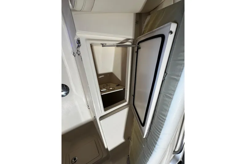 Slide: The Image of 2014 Grady-White Freedom 275 boat storage compartment with open hatch. - 6