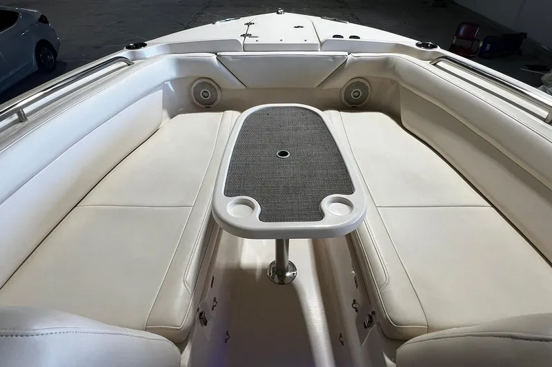 Slide: The Image of Interior of 2014 Grady-White Freedom 275 boat with cushioned seating and table. - 7