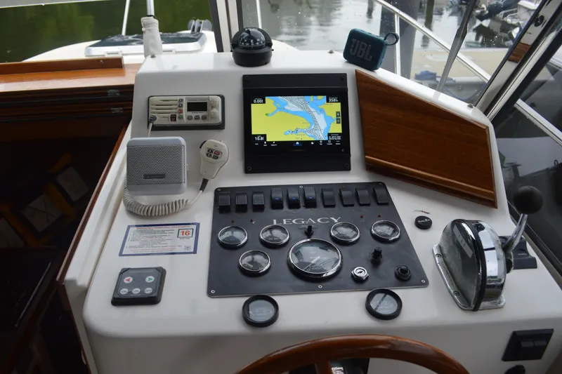 Slide: The Image of 2003 Legacy 28 Express boat dashboard with navigation controls and instruments. - 4