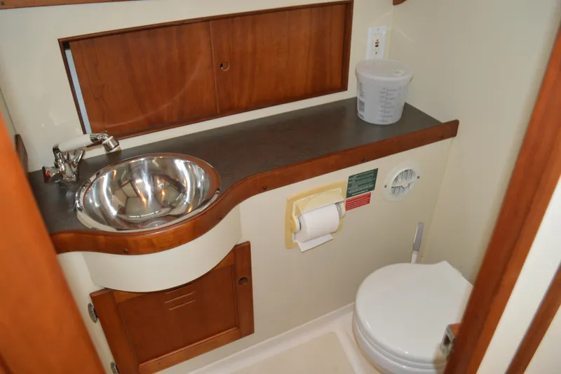 Slide: The Image of Compact bathroom in 2003 Legacy 28 Express boat with sink and toilet. - 11