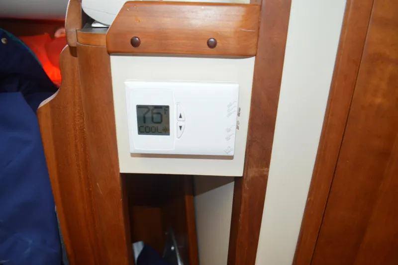 Slide: The Image of Thermostat set to 76°F in 2003 Legacy 28 Express boat interior. - 9